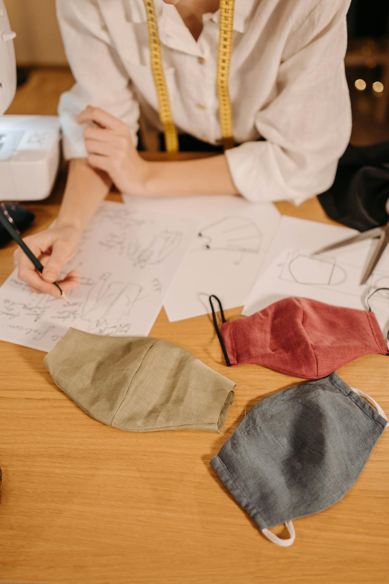 a fashion designer sketches face mask patterns