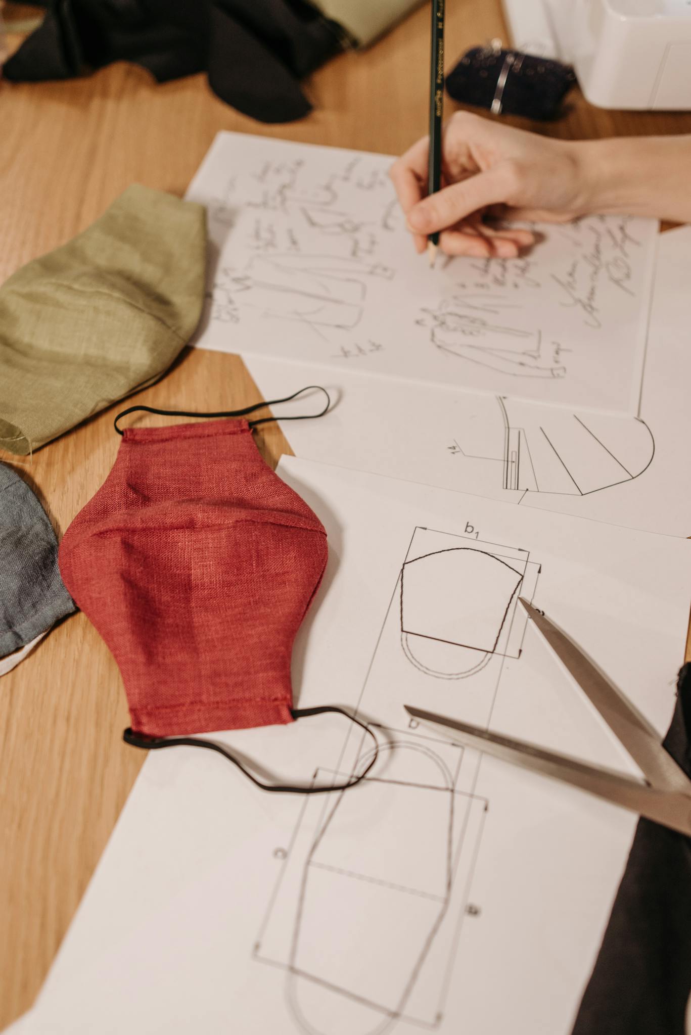 person designing face masks using fabric patterns